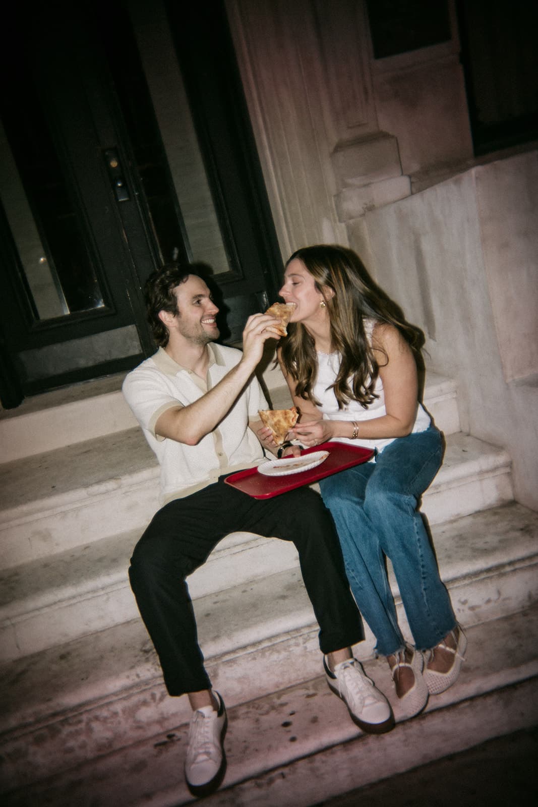 Rachel and Hugh sharing pizza on the steps